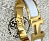 bracelet hermès clic h en métal doré et émail blanc