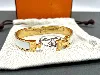 bracelet hermès clic h en métal doré et émail blanc