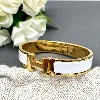 bracelet hermès clic h en métal doré et émail blanc