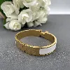 bracelet hermès clic h en métal doré et émail blanc