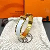 bracelet hermès clic h en métal doré et émail blanc