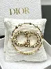 broche dior clair d lune en métal finition dorée, perles en résine blanche et cristaux blancs