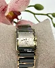 montre rado diastar movement quartz avec cadran noir, et boîtier et bracelet en acier doré et céramique