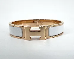 bracelet hermès clic h en métal doré et émail blanc