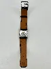 montre femme hermès glissade mouvment en quartz, boîtier en acier et bracelet en cuir noir