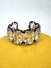 bracelet manchette swarovski harmonia en métal noir orné de cristaux blancs oversize taille coussin