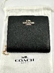 portefeuille coach à bouton pression en cuir noir