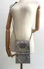 sac christian dior diorama vertical à chaîne en cuir verni métallisé argenté et clous dorés