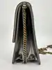 sac christian dior diorama vertical à chaîne en cuir verni métallisé argenté et clous dorés