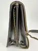 sac christian dior diorama vertical à chaîne en cuir verni métallisé argenté et clous dorés