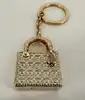 bijou de sac/porte-clés christian dior lady dior en métal doré, motif cannage