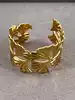 bracelet manchette motif feuille de ginkgo en acier doré