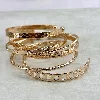 bracelet semainier 7 joncs ouverts en acier doré