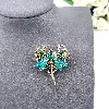 broche motif libellule en émail et en acier doré sertie d'oxydes