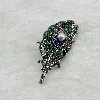 broche motif plume pavée d'oxydes en acier