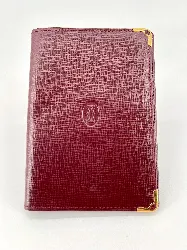 porte-cartes cartier must en cuir bordeaux avec finition dorée