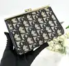 porte-monnaie/pochette vintage christian dior en toile jacquard beige et cuir bleu marine