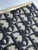 porte-monnaie/pochette vintage christian dior en toile jacquard beige et cuir bleu marine