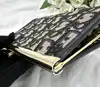 porte-monnaie/pochette vintage christian dior en toile jacquard beige et cuir bleu marine