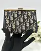 porte-monnaie/pochette vintage christian dior en toile jacquard beige et cuir bleu marine