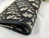 porte-monnaie/pochette vintage christian dior en toile jacquard beige et cuir bleu marine