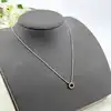 97397045 collier centré d'une pierre bleue et entournée des oxydes l45cm