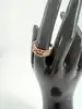 bague 3 rangs sertie d'oxydes roses et blancs en métal doré t62
