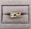 bague 3 rangs sertie d'oxydes verts et blancs en métal doré t62