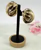 boucles d'oreilles clips dior vintage noeud tourbillon en métal doré