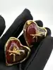boucles d'oreilles clips vintage christian lacroix coeur et étoile en métal doré et résine ambre