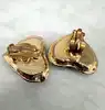 boucles d'oreilles clips vintage christian lacroix coeur et étoile en métal doré et résine ambre