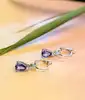 boucles d'oreilles dormeuses en or blanc chacune sertie d'une tanzanite forme poire surmontée d'un diamant taille brillant or 750 