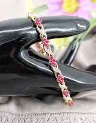 bracelet articulé en 2 ors orné des motifs fleur en rubis et motifs x chacun serti d'un diamant or 750 millième (18 ct) 10,90g