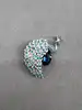 broche motif paon sertie d'oxydes bleus