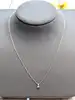 collier pendentif en or blanc serti de deux diamants de taille rond et taille trillion d'environ 0,13ct au total or 750 millième (