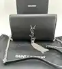 sac bandoulière yves saint laurent kate en cuir lisse noir avec pompon et finitions argentées