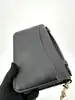 sac pochette coach en cuir grainé noir, chîne dorée détachable