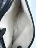 sac porté épaule paco rabanne en cuir lisse noir avec anse à disques métalliques