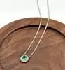 87398245 collier orné d'une pierre verte et entourée d'oxydes argent 925 millième (22 ct) 3g