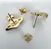 boucles d'oreilles vivienne westwood modèle harlequin orb doré et blanc