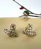 boucles d'oreilles vivienne westwood modèle harlequin orb doré et blanc