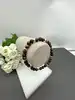 bracelet élastiqué boules en pierre oeil de tigre, oeil de taureau et oeil de faucon d6,5mm et métal doré d4mm
