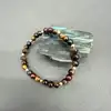 bracelet élastiqué boules en pierre oeil de tigre, oeil de taureau et oeil de faucon d6,5mm et métal doré d4mm