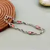 bracelet en argent orné de perles roses logées dans des maillons ajourés argent autre 6,63g