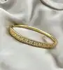 bracelet jonc orné d'oxydes en métal doré