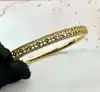 bracelet jonc orné d'oxydes en métal doré
