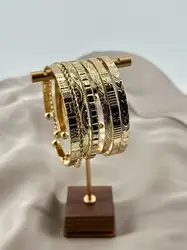 bracelet semainier 7 joncs ouverts en acier doré