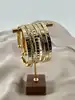 bracelet semainier 7 joncs ouverts en acier doré