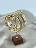 bracelet semainier 7 joncs ouverts en acier doré