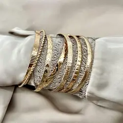 bracelet semainier 7 joncs ouverts en acier doré